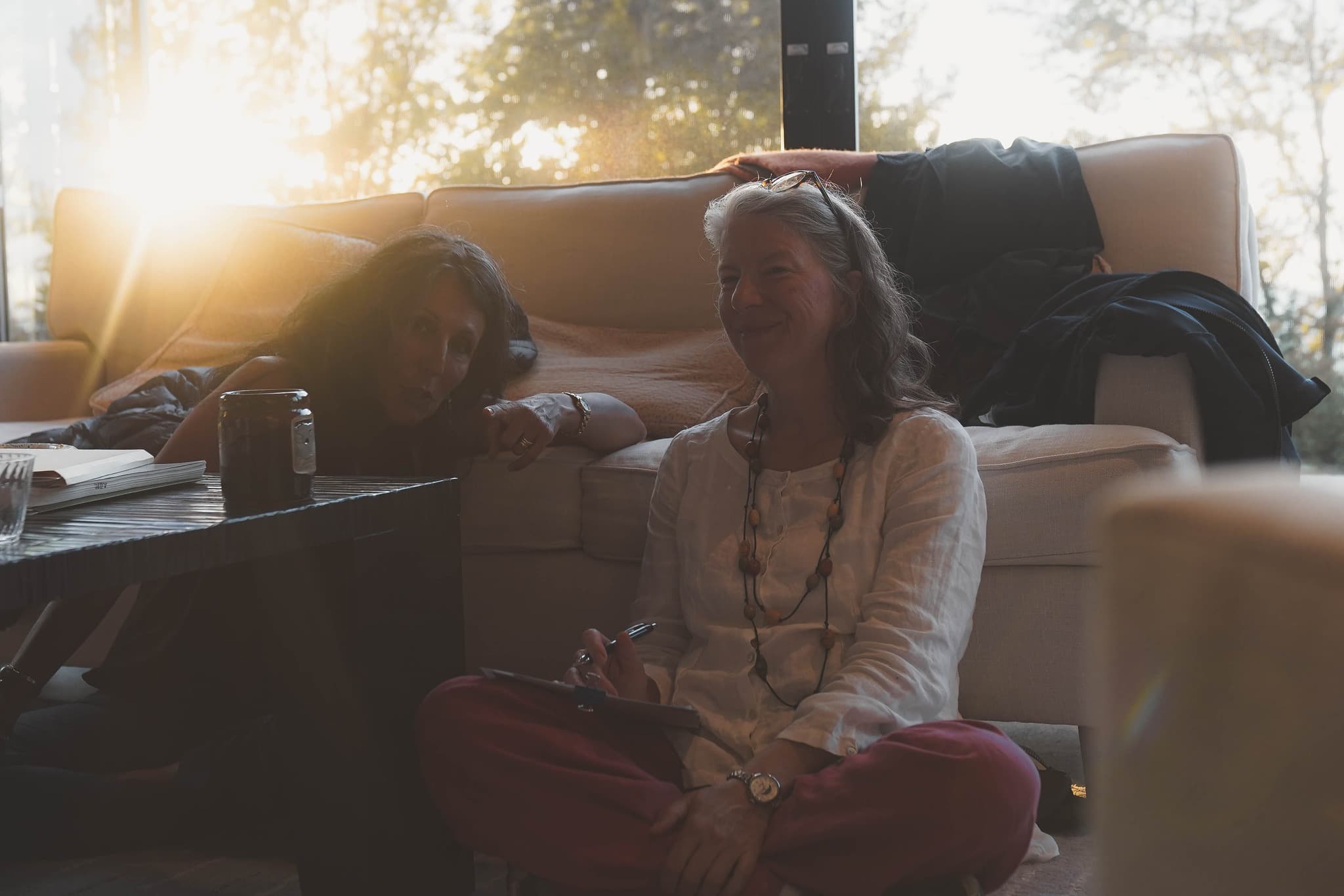 Friends gathered together in warm golden-hour light at the retreat
